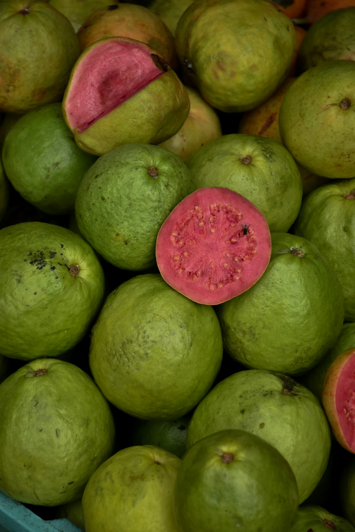 Fresh guavas stacked together at a market