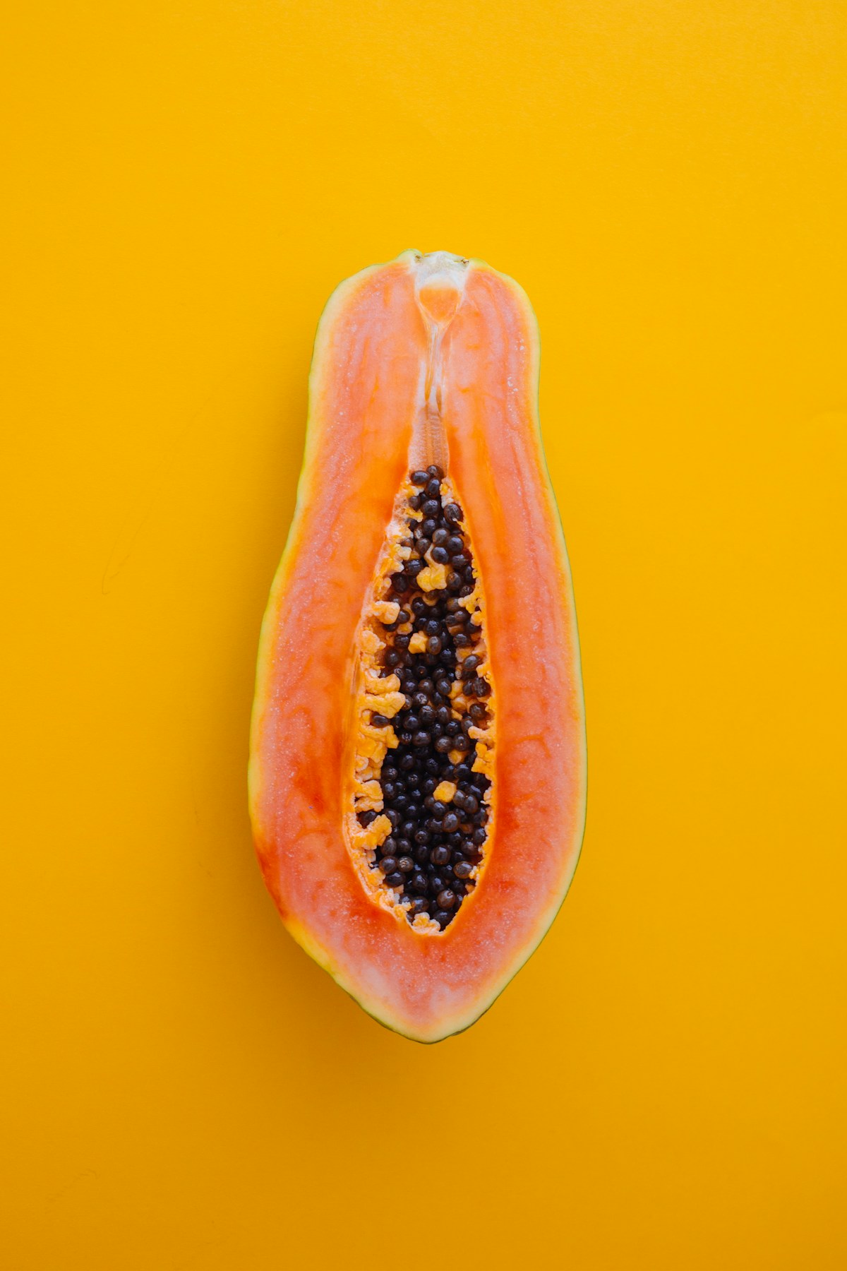 Sliced papaya halves arranged on a blue background
